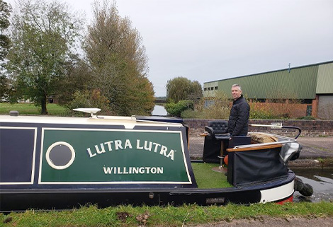 Steve Burt at the helm of narrowboat Lutra Lutra