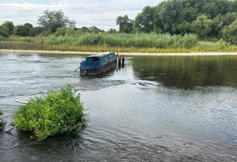 narrowboat grounded on the River Trent near Sawley Locks